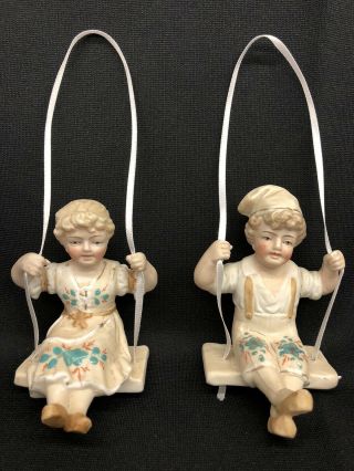 Pair C.  1900’s German Bisque Hand Painted Swinger Dolls For Hanging Oil Lamp Nr