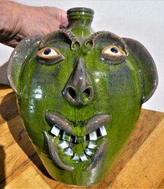 A.  V.  Smith North Carolina Pottery Large Folk Art.  Green " Smilng " Ugly Face Jug