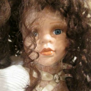 Seymour Mann Porcelain Doll With Brown Curly Hair And Blue Eyes
