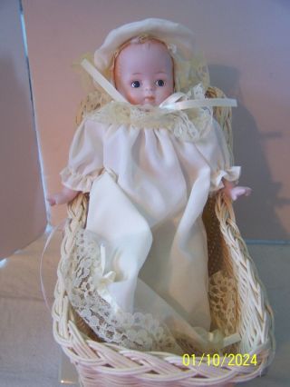 Musical Porcelain Baby Doll In Wicker Basket