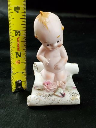Vintage Bisque Kewpie Doll Sitting On Porcelain Scroll With Pink Roses Figurine