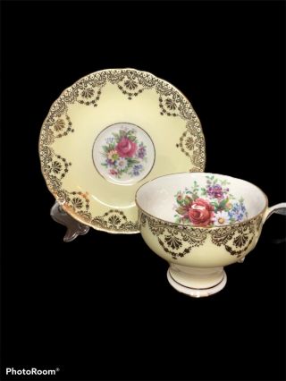 Paragon Yellow And Gold Footed Tea Cup And Saucer With Flowers