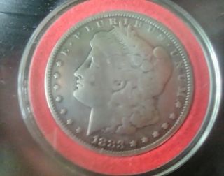 1883 Cc Morgan Silver Dollar.  In Airtight Capsule.  A Good Quality Coin.