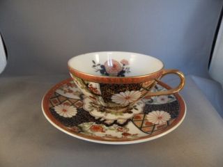 Japan Porcelain Cup And Saucer 999 - J Oriental Flower Red Blue Gold Accents 1970s