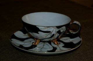 Vintage Black,  White,  And Gold,  Three Footed Tea Cup And Saucer