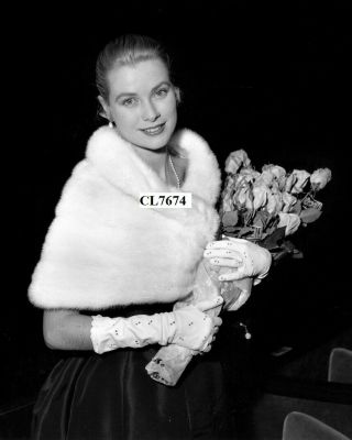 Grace Kelly Wearing A Fur Stole And Carrying A Bouquet Of Roses In Cannes Photo