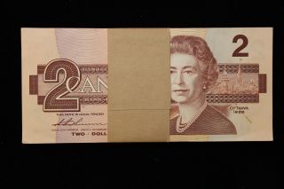1986 Canada.  ($2) Two Dollars.  100 X Consecutive Notes With Band.  Series Cbh