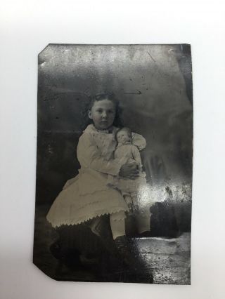 Antique Tintype Photograph Young Girl White Dress Holding Toy Doll In Arms