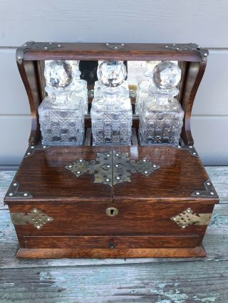 Antique English Victorian Oak Tantalus Triple Crystal Decanter Set Circa 1870