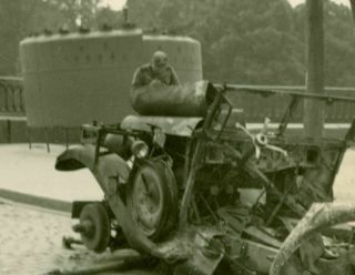 German soldier and destroyed German vehicle,  WW2.  Photo 2