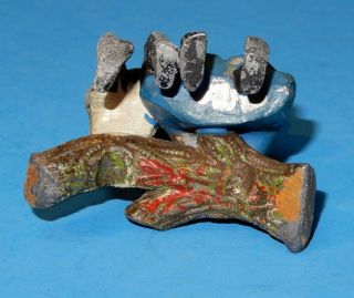old lead figure of a black boy comforting a girl sitting on a log 3