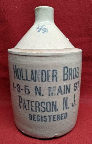 Antique Jug Paterson Nj Hollander Bros.  1 - 3 - 5 N.  Main St.  Registered,  1/2 Gallon