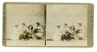 Woman With Large Folding Camera With Friends In Studio Beach Scene