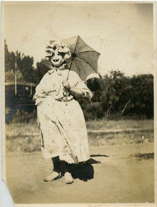1920s Snapshot Photo.  Scary Mask Costume.  Dress And Umbrella