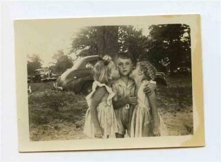 2 Little Girls Kissing A Little Boy On The Cheeks Black & White Photo 1930 