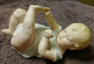 Antique German Gebruder Heubach Bisque Piano Baby Boy On Back Touching Toes