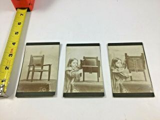 3 Vintage Photos Of A Small Girl Demonstrating How A Folding Chair Functions.