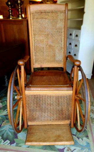 Antique Oak Wheelchair Caned Back Museum Quality.  Local Pick Up Only