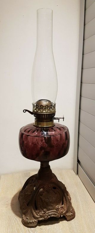 Antique Cherry Glass Oil Lamp With Cast Iron Base:
