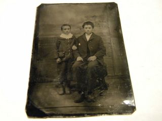 An Antique Tintype Of Two Ruddy Faced Grumpy Looking Young Boys