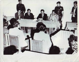 Iraq.  Photo Of Saddam Hussain In An Official Meeting,  1979.  001001