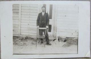 Vintage Postcard B & W Photo Man Behind A Chair.  Subject Unknown