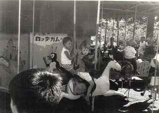 Old Photo Kids Riding Carousel In Asian Country