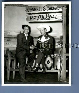 Found B&w Photo V,  0145 Man In Suit Sitting By Other In Costume Under Sign