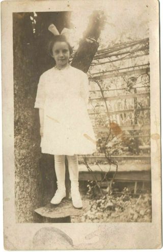 Postcard 1910 Rppc Young Girl Bow Tie Standing On Giant Mushroom Next To Tree