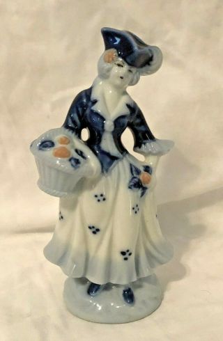 Blue And White Porcelain Colonial Figurine - Woman With Basket Of Flowers