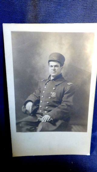 Rppc: Seated Police Officer In Uniform W/badge,  Holding Gloves
