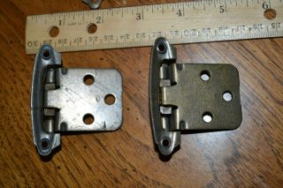 Set of 8 antique brass spring loaded cabinet hinges. 3