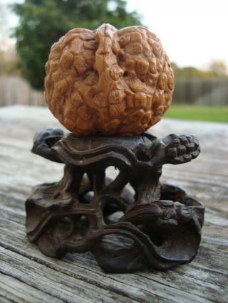 Old Chinese Hand Carved Walnut With Many Faces On Wood Lily Pad Stand