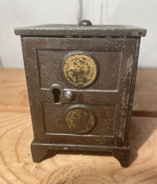 Antique Cast Iron Still Bank Safe 2 Coins On Door - No Key.  Piggy Bank 3”h