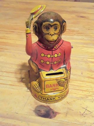 J Chien Tin Monkey Raising Hat Toy Bank