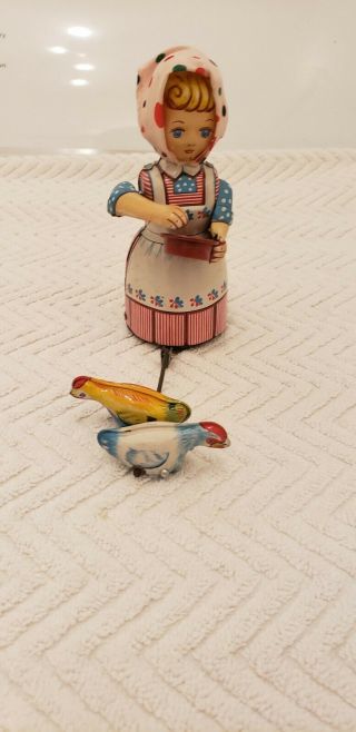 T.  P.  S.  Girl Feeding Chickens Windup Tin Toy Japan Circa 1950s