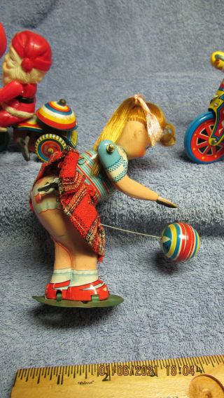 3 vintage tin wind - up toys - girl bouncing a ball and two Santas. 2