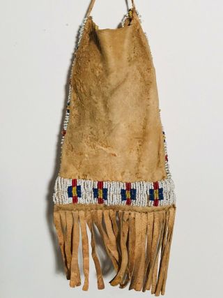 19TH C SIOUX SINEW BEADED FRINGED HIDE BAG,  WHITE HEART RED - BLUE - YELLOW - WHITE,  NR 2