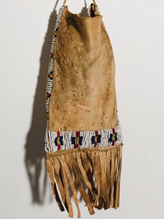 19TH C SIOUX SINEW BEADED FRINGED HIDE BAG,  WHITE HEART RED - BLUE - YELLOW - WHITE,  NR 3