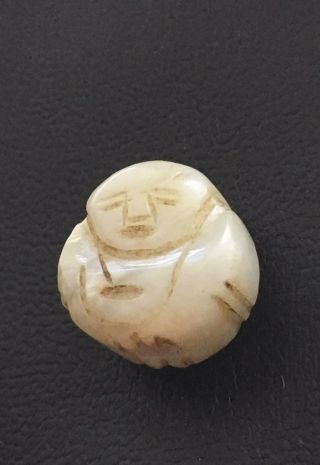 A Small Chinese Jade Carving With A Vertical Hole In The Figure
