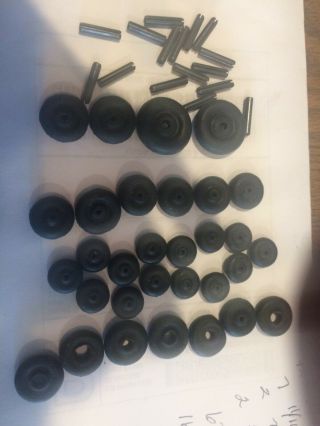 31 Small Black Hard Rubber Wheels.  14 1/2 - 7 11/16 - 2 7/8 - 6 5/8 16 Axels