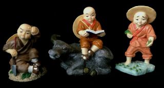 Three Asian Monk Bald Boy Resin Figurines - Reading On Ox,  Planting,  Chopping Wood