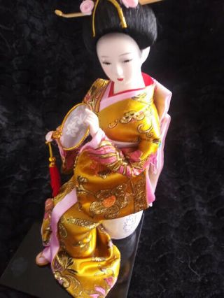 Vintage Japanese Geisha Doll 11 Tall In Seated Position On A Barrel.