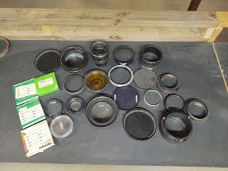 Various Vintage Camera Lenses And Covers