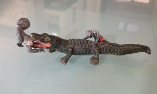 Vintage Black Americana Metal Sculpture - Alligator Biting Boy