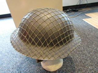 WWII British 1939 JCS and W marked helmet with chin strap,  liner,  and camo net 2