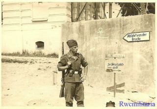 Port.  Photo: OCCUPATION Luftwaffe Rifleman on Street by Signs; PLESKAU,  Russia 2