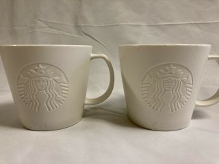 Two 2015 Starbucks Solid White Embossed Mermaid Mugs 12 Oz.  T Coffee Mug Cup