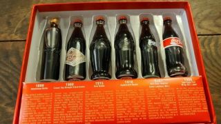 Evolution Of The Coca - Cola Contour Bottle,  6 Mini Bottles Of Coke - Display Only