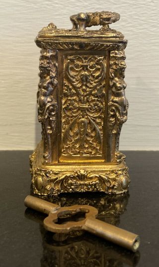 a gilt figural miniature carriage clock with circular enamel dial 3